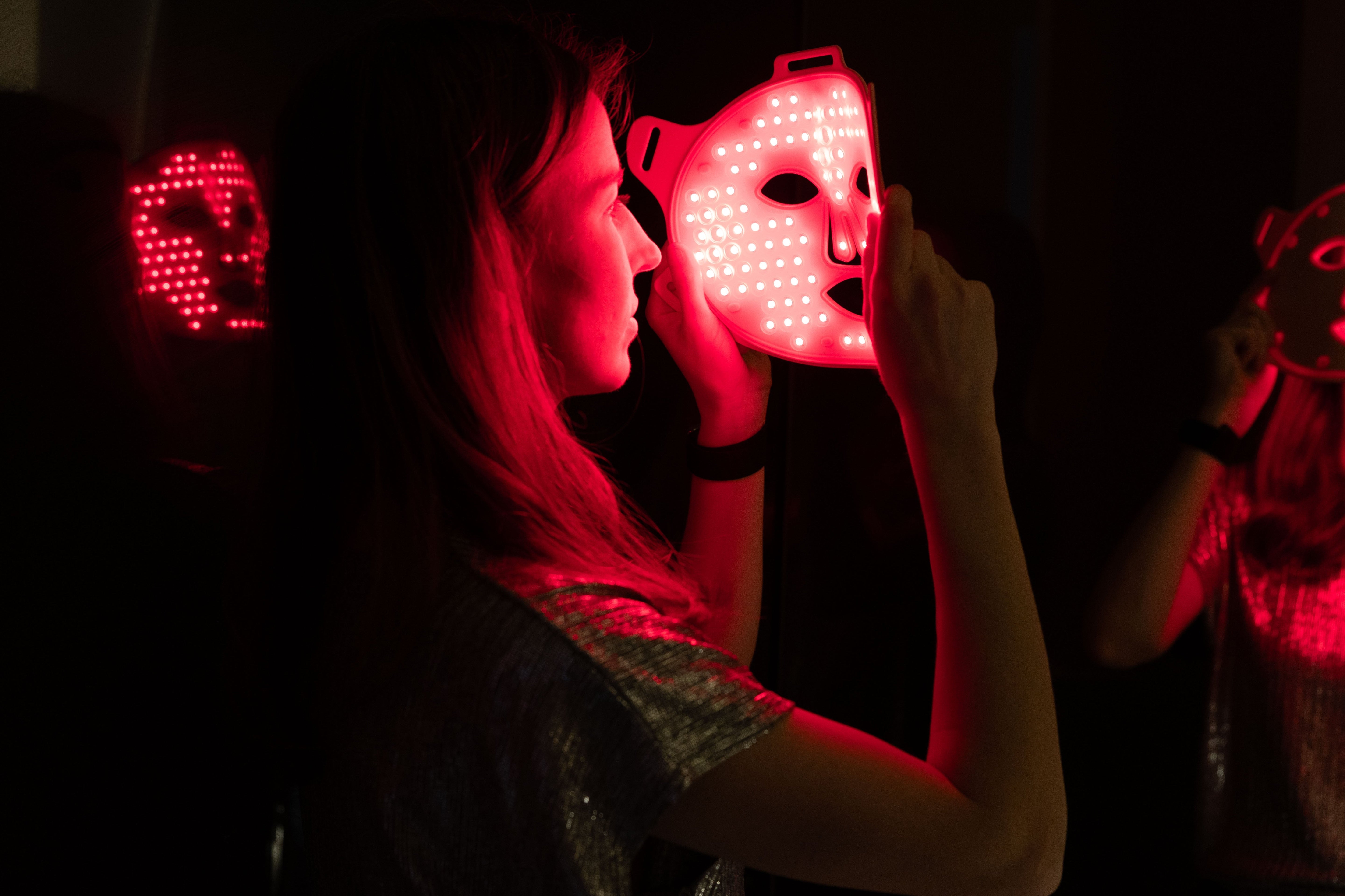 Model looking into the The Pink Edition LED FAce Mask 